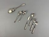 five spoons and two spoons sitting on a table