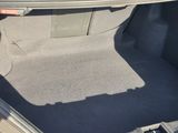 the trunk of a car with the seat folded down and the floor mat folded down