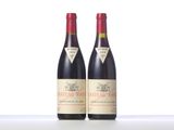 two bottles of red wine sitting next to each other on a table