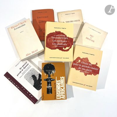 several books sitting on top of each other on a white surface
