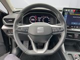 the interior of a car with a steering wheel, dashboard, and display screen