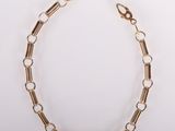 a gold chain bracelet with links on a white background