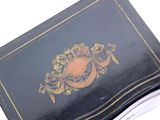 a black and gold box on a white surface