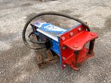 a red and blue machine that is sitting on the ground