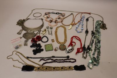 many necklaces and bracelets laid out on a table