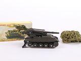 un petit char miniature à côté d'une boîte de cannabis