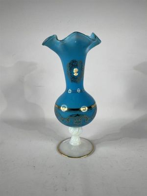 a blue vase that is sitting on a glass stand