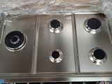 four burners on the stove in the kitchen