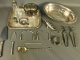 a silver tray with silverware and silver spoons and utensils