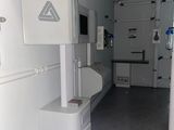 an image of a hospital room with a sink and a refrigerator