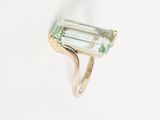 an image of a green tourmaline ring on a white surface