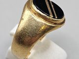 a close up of a gold ring with a black stone on it