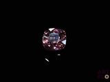 a close up of a pink diamond on a black background