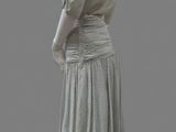 an image of a mannequin wearing a gray dress and white shoes