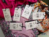 a pile of clothes with price tags on them