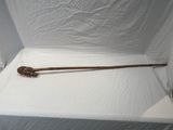a wooden stick sitting on top of a white sheet