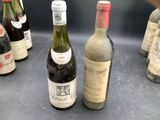 several bottles of wine are lined up on a table