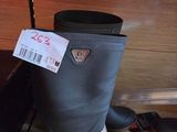 a pair of boots sitting on the floor next to a suitcase