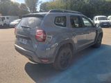 a grey car that is parked in a parking lot