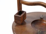 a wooden chair that has a wooden cup holder on top of it