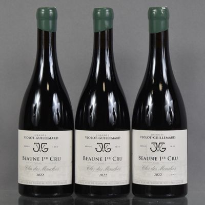 three bottles of red wine are lined up on a table
