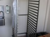 an image of a metal rack in the corner of a room