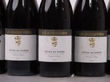 six bottles of red wine are lined up in a row