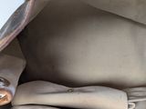 a close up of a purse with a button on it