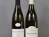 two bottles of wine sitting on top of a table next to each other