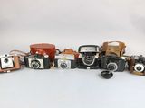 a lot of cameras that are sitting on a table