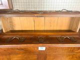 a wooden dresser with a mirror on top of it