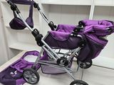 a purple stroller sitting on a table next to a bookcase