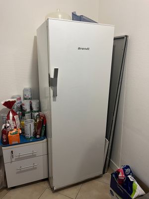 a white refrigerator in the corner of a room