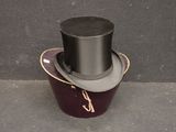 a black top hat sitting on top of a red box