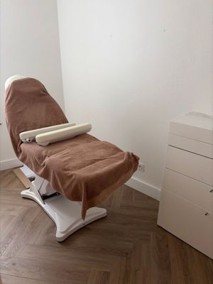 an image of a chair with a blanket on it in a room