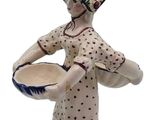 a figurine of a woman holding a bowl