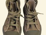 a pair of shoes that are on a white surface