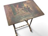 a small table with a painting on it on a white background