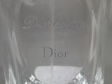 a clear glass bottle with a white label on it that says dior