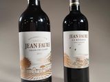 two bottles of wine sitting next to each other on a table