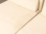 a white couch that has two pillows on top of it