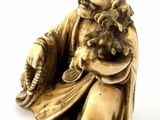 statue of a man holding a cat and a dog on a white surface