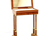 a small wooden desk with a mirror on top of it