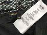 the label on the back of a black pants with a white tag on it