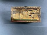 a box with a painting on it sitting on a table