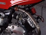 a red motorcycle that is parked in a garage
