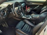 the interior of a car with the door open showing the steering wheel and dashboard