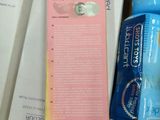 a bottle of toothpaste and a tube of toothpaste next to a package of toothpaste