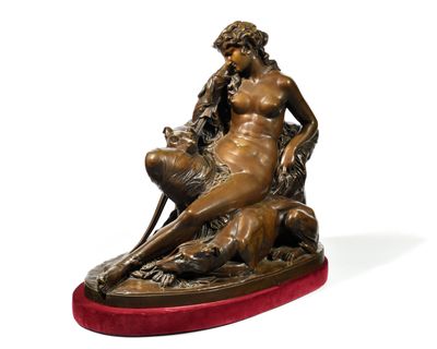 statue en bronze représentant une femme assise sur un rocher avec un chien