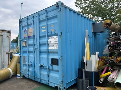 a large blue container with pipes and pipes in it